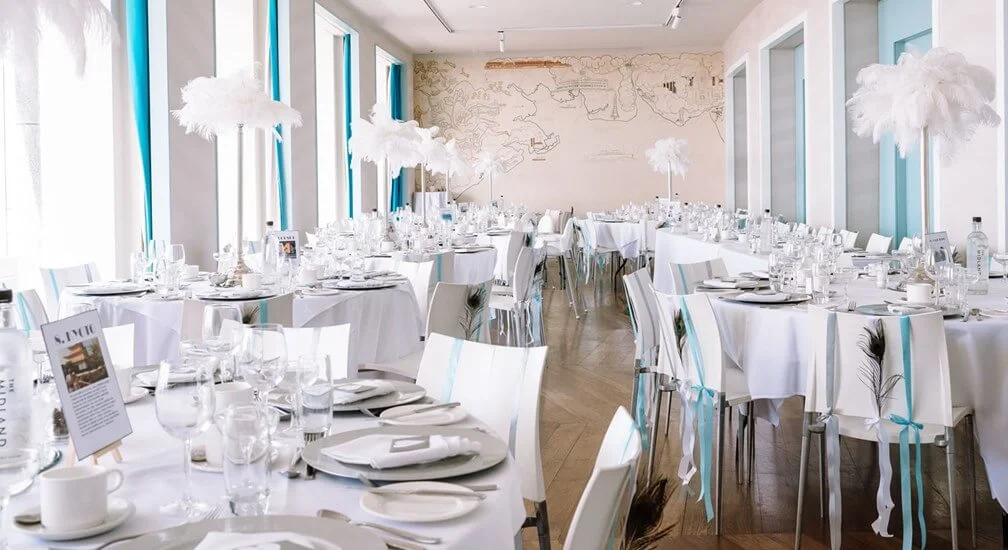 Function room set for a banquet with round tables